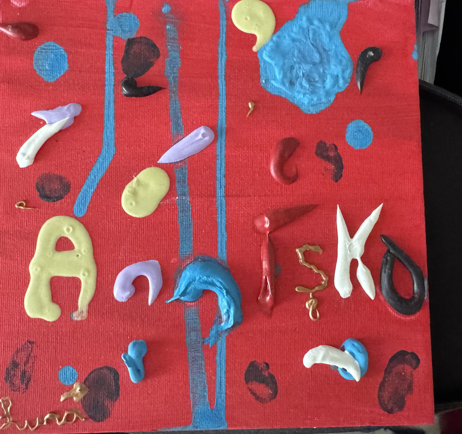 Colourful 3D paint letters on red canvas with blue vertical stripes